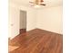 Bright bedroom featuring hardwood floors and ceiling fan at 120 W Academy St, Wendell, NC 27591