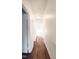 Long hallway with hardwood floors and light walls at 120 W Academy St, Wendell, NC 27591