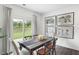 Bright dining room with wooden table and access to backyard at 1204 Caledon Dr # 183, Mebane, NC 27302