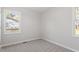 Simple bedroom with neutral walls, carpet flooring, and a window at 124 W College St, Oxford, NC 27565