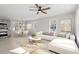 Open concept living and dining area with L-shaped sofa and round dining table at 124 W College St, Oxford, NC 27565