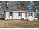 Newly renovated ranch home with red door and landscaping at 124 W College St, Oxford, NC 27565