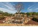 Impressive entrance features a stone water feature and flag display at 129 Mayan Dr, Louisburg, NC 27549