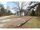 Residential street with a white house and trees at 13 Alton Dr, Louisburg, NC 27549