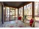 Screened porch with wooded views, seating, and rug at 14 Melstone Turn, Durham, NC 27707