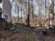 Stone walkway beside home leads to private wooded backyard at 1416 Mahonia Ct, Raleigh, NC 27615