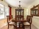 Formal dining room with a wood table, chandelier, and china cabinet at 1416 Mahonia Ct, Raleigh, NC 27615