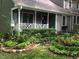 House exterior with lush landscaping and a charming porch at 1416 Mahonia Ct, Raleigh, NC 27615