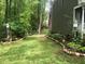 Landscaped side yard with stone border and lush greenery at 1416 Mahonia Ct, Raleigh, NC 27615