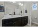 Bathroom with double vanity and view into another room at 143 Manordale Dr, Chapel Hill, NC 27517