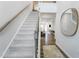 Bright entryway with staircase, hardwood floors, and a stylish mirror at 143 S Finley Landing Pkwy, Smithfield, NC 27577