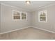 Spacious bedroom featuring two windows and neutral carpeting at 1619 Milan St, Durham, NC 27704