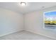 Simple bedroom with grey carpet and a single window at 167 S Finley Landing Pkwy # 80, Smithfield, NC 27577