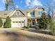 Two-story house with a front yard, two-car garage, and landscaping at 2077 Tordelo Pl, Apex, NC 27502