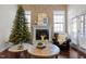 Living room with fireplace, large windows, and comfortable seating at 2077 Tordelo Pl, Apex, NC 27502