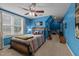 Blue bedroom with a wooden bed frame and adjacent workspace at 2603 Churchill Dr, Burlington, NC 27215