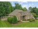 Stone and brick home with lush landscaping and a spacious yard at 2603 Churchill Dr, Burlington, NC 27215