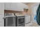 Laundry room with washer, dryer, and ample cabinet space at 2603 Churchill Dr, Burlington, NC 27215