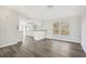 Open concept dining area with grey vinyl plank flooring and kitchen view at 292 Valley Forge S Way, Cameron, NC 28326