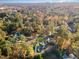 Aerial view showcasing home's setting within a wooded neighborhood at 3319 Milton Rd, Raleigh, NC 27609