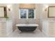Bathroom with black clawfoot tub and patterned floor tile at 3319 Milton Rd, Raleigh, NC 27609