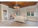 Charming bedroom with a tufted bed and large windows at 3319 Milton Rd, Raleigh, NC 27609