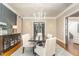 Formal dining room with dark wood table and white chairs at 3319 Milton Rd, Raleigh, NC 27609
