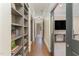 Bright hallway with built-in bookcases and hardwood floors at 3319 Milton Rd, Raleigh, NC 27609