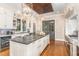 White kitchen with dark wood ceiling and large island at 3319 Milton Rd, Raleigh, NC 27609