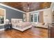 Spacious main bedroom with hardwood floors, wood ceiling, and a cozy sitting area at 3319 Milton Rd, Raleigh, NC 27609