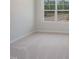 Bright bedroom with large window and carpet at 398 Thompson Overlook Way # 251, Smithfield, NC 27577