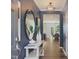 Bright entryway with navy wallpaper, a console table, and mirror at 398 Thompson Overlook Way # 251, Smithfield, NC 27577