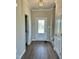 Bright entryway with hardwood floors, leading to stairs and a half-bath at 40 Misty Mountain, Spring Hope, NC 27882