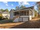 Gray house with screened porch and deck, situated on a grassy lot with mature trees at 419 Carolina Way, Sanford, NC 27332