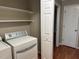 Laundry area with washer, dryer, and extra shelving at 427 Overman Drive Dr, Burlington, NC 27215