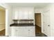 White kitchen cabinets and dark countertops at 4633 Lily Walk, Rocky Mount, NC 27804