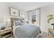 Serene bedroom with light blue bedding and large window at 1507 Village Hall Ln # 35, Wake Forest, NC 27587