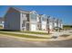 Row of townhouses with gray siding, two-car garages, and landscaping at 513 Fife Ct, Gibsonville, NC 27249