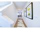 Long hallway with wood-look flooring and artwork leading to living room at 513 Fife Ct, Gibsonville, NC 27249