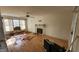 Living room with hardwood floors, fireplace, and ceiling fan; undergoing renovations at 5236 Turf Grass Ct, Raleigh, NC 27610