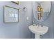 Elegant powder room with pedestal sink and framed art at 604 Market Grove Dr # 100, Wake Forest, NC 27587