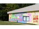 Building exterior with a vibrant mural depicting downtown Wake Forest at 604 Market Grove Dr # 100, Wake Forest, NC 27587