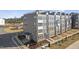 Modern three-story townhome with gray siding and brick accents at 604 Market Grove Dr # 100, Wake Forest, NC 27587