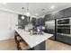 Modern kitchen with white countertops, stainless steel appliances, and ample cabinet space at 604 Market Grove Dr # 100, Wake Forest, NC 27587
