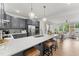 Open concept kitchen boasts white countertops, stainless steel appliances, and an island with seating at 604 Market Grove Dr # 100, Wake Forest, NC 27587