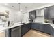 Stylish kitchen with gray cabinets, white countertops, and a large island at 604 Market Grove Dr # 100, Wake Forest, NC 27587