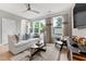 Bright living room with large windows, comfy seating, and stylish decor at 604 Market Grove Dr # 100, Wake Forest, NC 27587