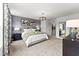Spacious primary suite with plush bed and gray accents at 604 Market Grove Dr # 100, Wake Forest, NC 27587