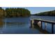 Serene lake view with a concrete pier and surrounding trees at 606 Market Grove Dr # 200, Wake Forest, NC 27587