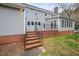 Backyard with brick stairs leading to a patio and surrounded by trees at 624 Great Pine Way, Raleigh, NC 27614